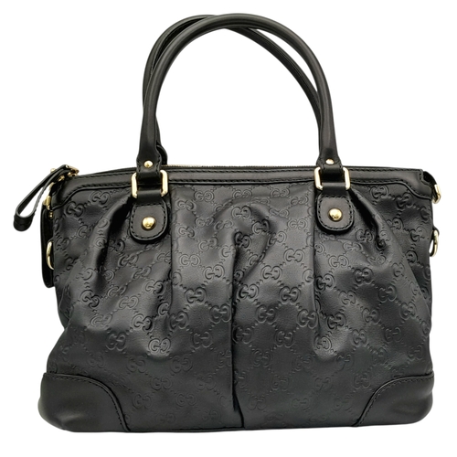 232 - A Gucci Guccissima Sukey Handbag. Black GG monogram embossed leather exterior with silver-tone hardw... 