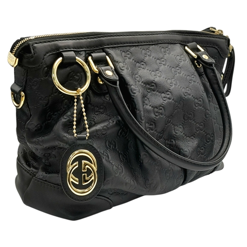 232 - A Gucci Guccissima Sukey Handbag. Black GG monogram embossed leather exterior with silver-tone hardw... 
