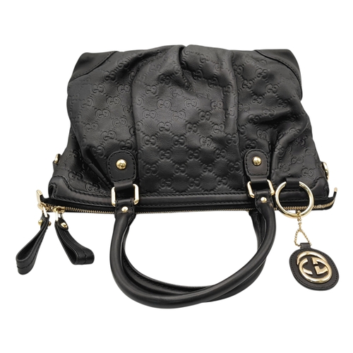 232 - A Gucci Guccissima Sukey Handbag. Black GG monogram embossed leather exterior with silver-tone hardw... 