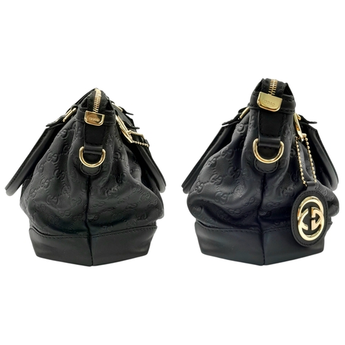 232 - A Gucci Guccissima Sukey Handbag. Black GG monogram embossed leather exterior with silver-tone hardw... 