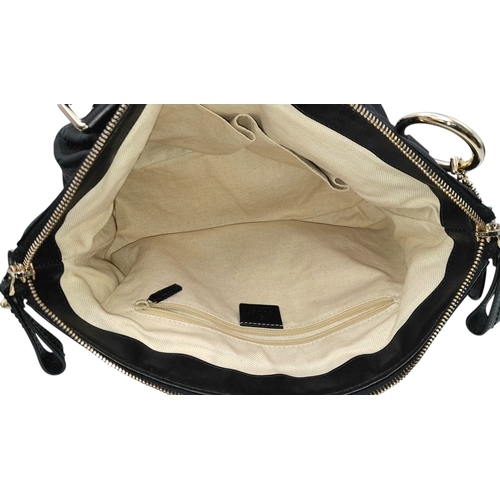 232 - A Gucci Guccissima Sukey Handbag. Black GG monogram embossed leather exterior with silver-tone hardw... 