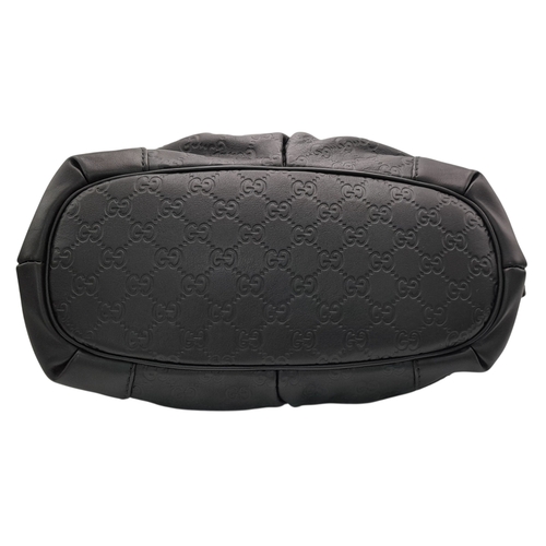 232 - A Gucci Guccissima Sukey Handbag. Black GG monogram embossed leather exterior with silver-tone hardw... 
