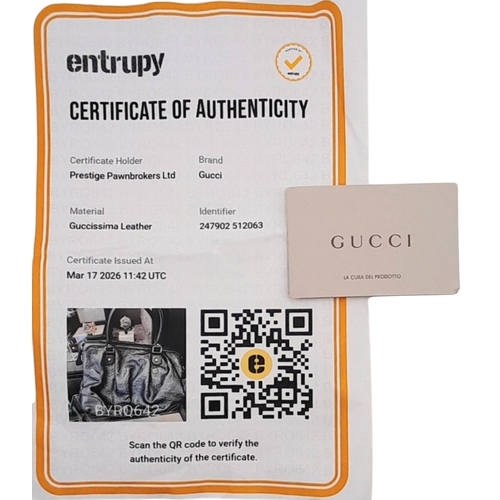 232 - A Gucci Guccissima Sukey Handbag. Black GG monogram embossed leather exterior with silver-tone hardw... 