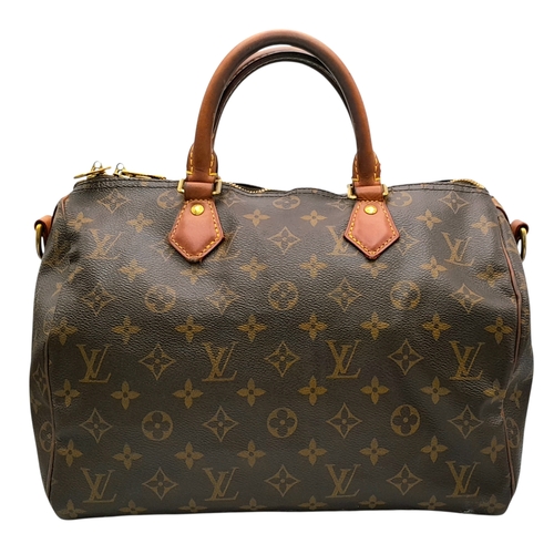 303 - A Louis Vuitton Monogram Speedy 30 Handbag. Signature brown monogram coated canvas exterior with vac... 