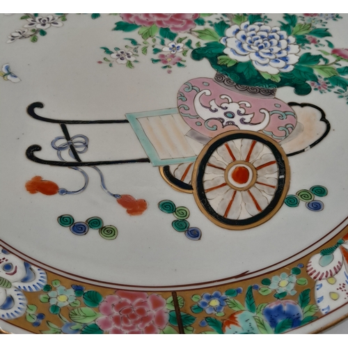 309 - An Antique Chinese Porcelain Decorative Charger. Famille rose design with a floral cart scene. Marki... 