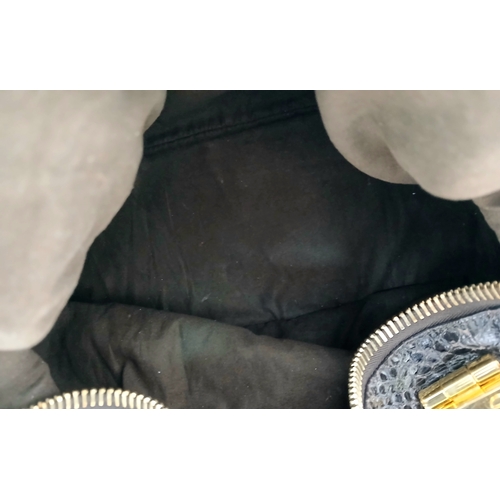 317 - A Tom Ford Python Skin Leather Handbag. Crafted in dark brown genuine python skin with a rich, natur... 