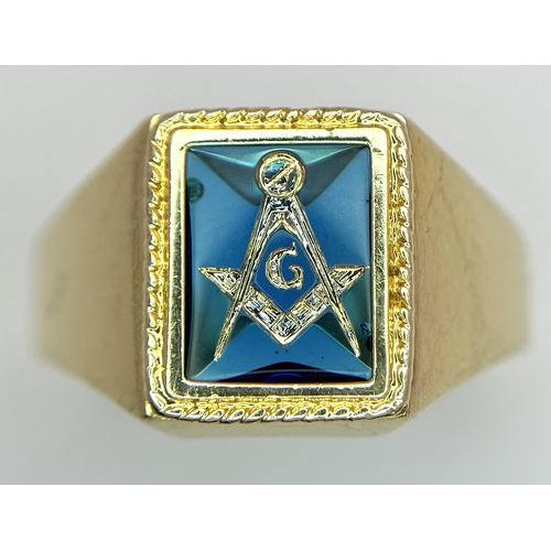 323 - A 14K Yellow Gold and Blue Stone Gents Masonic Signet Ring. Size T. 6.45g. Ref: 27614.