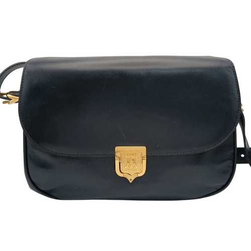 338 - A Céline Vintage Navy Triomphe Shoulder Bag. Navy leather exterior with gold-tone hardware, Triomphe... 