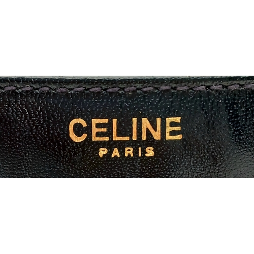 338 - A Céline Vintage Navy Triomphe Shoulder Bag. Navy leather exterior with gold-tone hardware, Triomphe... 