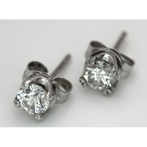 353 - A Pair of 18K White Gold and Diamond Stud Earrings. 0.70ctw. 1.2g total weight.