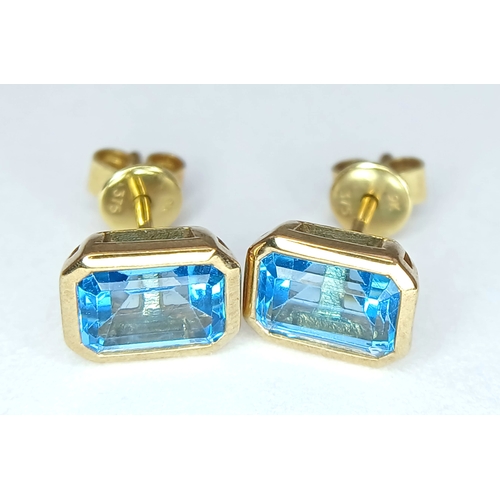 355 - A PAIR OF 9K YELLOW GOLD, BLUE TOPAZ SET, STUD EARRINGS. 2.1G. MS RED 1004