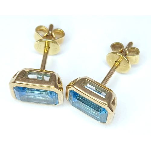 355 - A PAIR OF 9K YELLOW GOLD, BLUE TOPAZ SET, STUD EARRINGS. 2.1G. MS RED 1004