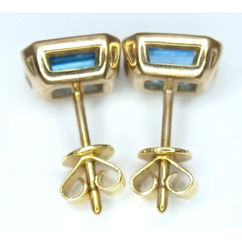 355 - A PAIR OF 9K YELLOW GOLD, BLUE TOPAZ SET, STUD EARRINGS. 2.1G. MS RED 1004