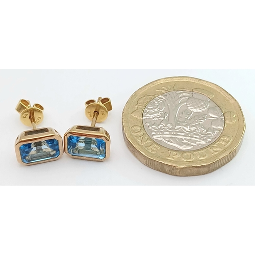355 - A PAIR OF 9K YELLOW GOLD, BLUE TOPAZ SET, STUD EARRINGS. 2.1G. MS RED 1004