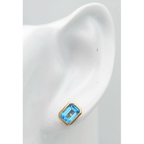 355 - A PAIR OF 9K YELLOW GOLD, BLUE TOPAZ SET, STUD EARRINGS. 2.1G. MS RED 1004
