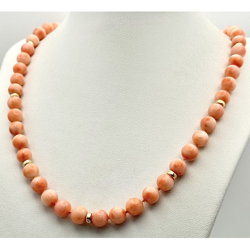 356 - An 18K Gold and Red Coral Necklace. 8mm coral beads. 60cm necklace length. 50.6g. MT16.
