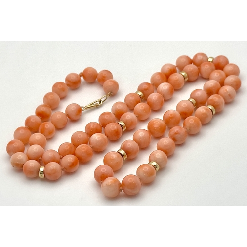 356 - An 18K Gold and Red Coral Necklace. 8mm coral beads. 60cm necklace length. 50.6g. MT16.