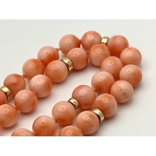 356 - An 18K Gold and Red Coral Necklace. 8mm coral beads. 60cm necklace length. 50.6g. MT16.