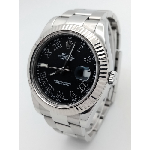 A Rolex Datejust II Gents Automatic Watch. Model 116334. Stainless steel bracelet and  case - 41mm. Fluted bezel. Black dial with Roman numerals and date window. In good condition and working order. Comes with spare link, box, Watch Register and WCSA report. Ref: 27403
