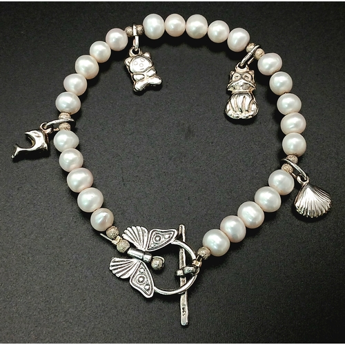 108 - A pretty 925 silver charm and freshwater pearl bracelet. Approx 17cm length. Please see photos for d... 