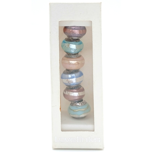 85 - A Lovelinks 925 Silver Charm Bead Set. Comprising a selection of glass charm beads with 925 silver c... 