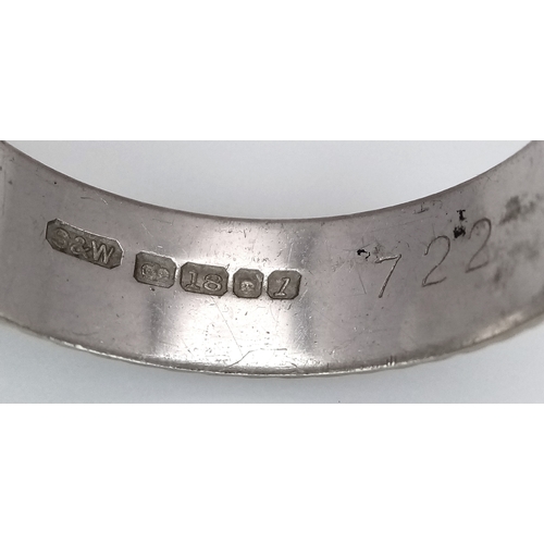 3 - An 18K White Gold Band Ring. Textured chevron exterior band pattern. Size T 1/2. 7mm width. 5.6g.