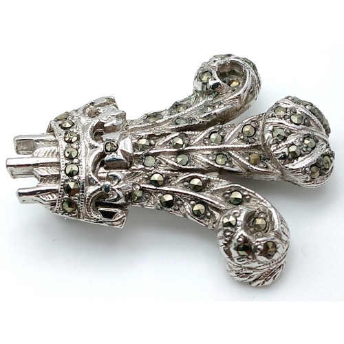 226 - A Prince of Wales Feathers Marcasite Set Brooch. Featuring a stylised three-feather motif set with m... 