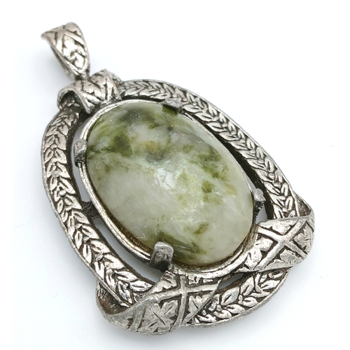 304 - A Green Hardstone Pendant in Ornate Mount. Approx 5cm x 3cm. Please see photos for details.
