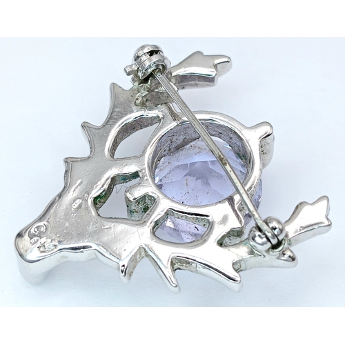 71 - A Deer Head Brooch with Blue Stone. Set with a central round-cut blue stone within a stag head desig... 