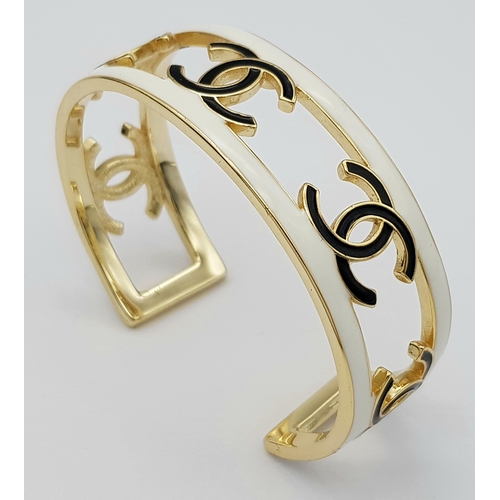 115 - A Chanel CC Logo 24C Gold-Toned Metal and White Enamel Arm Cuff Bracelet. Chanel CC Logo Wide Bangle... 