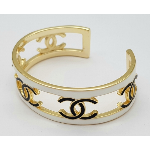 115 - A Chanel CC Logo 24C Gold-Toned Metal and White Enamel Arm Cuff Bracelet. Chanel CC Logo Wide Bangle... 