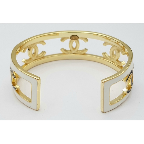 115 - A Chanel CC Logo 24C Gold-Toned Metal and White Enamel Arm Cuff Bracelet. Chanel CC Logo Wide Bangle... 