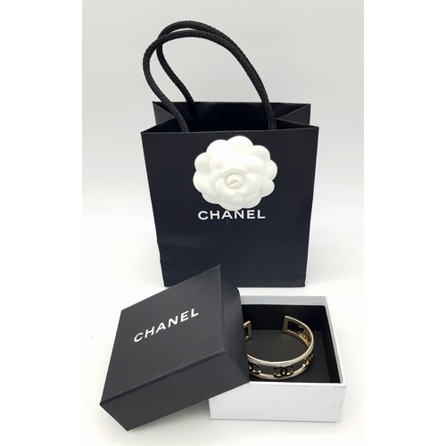 115 - A Chanel CC Logo 24C Gold-Toned Metal and White Enamel Arm Cuff Bracelet. Chanel CC Logo Wide Bangle... 