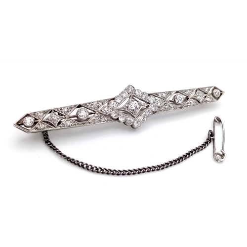 40 - An Exceptional Antique Art Deco Platinum, 18K Gold, Diamond Bar Brooch. Intricate filigree and openw... 