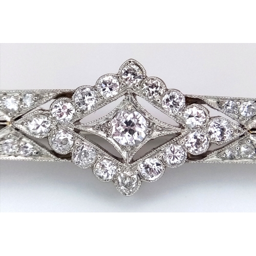 40 - An Exceptional Antique Art Deco Platinum, 18K Gold, Diamond Bar Brooch. Intricate filigree and openw... 
