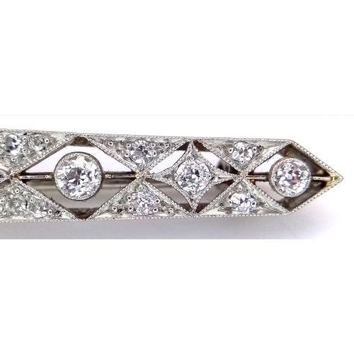 40 - An Exceptional Antique Art Deco Platinum, 18K Gold, Diamond Bar Brooch. Intricate filigree and openw... 