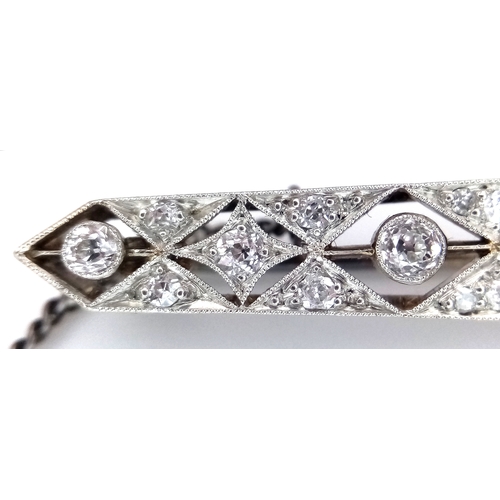 40 - An Exceptional Antique Art Deco Platinum, 18K Gold, Diamond Bar Brooch. Intricate filigree and openw... 