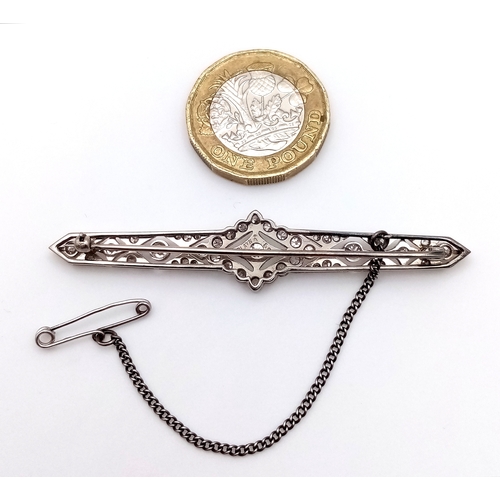 40 - An Exceptional Antique Art Deco Platinum, 18K Gold, Diamond Bar Brooch. Intricate filigree and openw... 