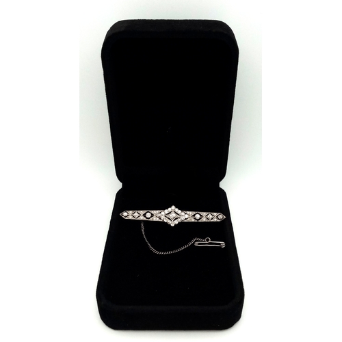 40 - An Exceptional Antique Art Deco Platinum, 18K Gold, Diamond Bar Brooch. Intricate filigree and openw... 