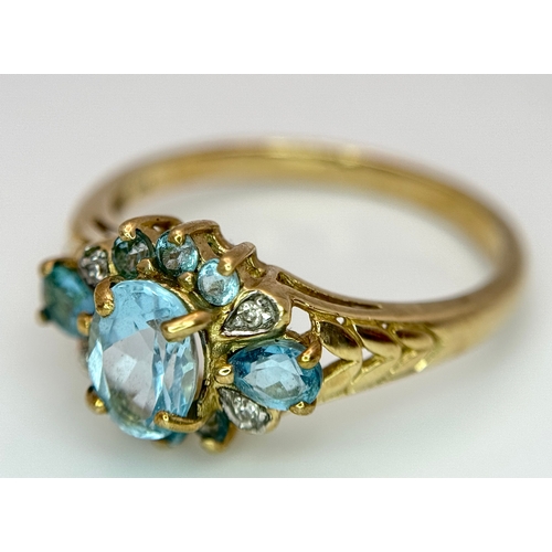 1266 - An Impressive 9K Gold Blue Topaz and Diamond Set Ring Size Q1/2. The Ring is set with a Centre Oval ... 