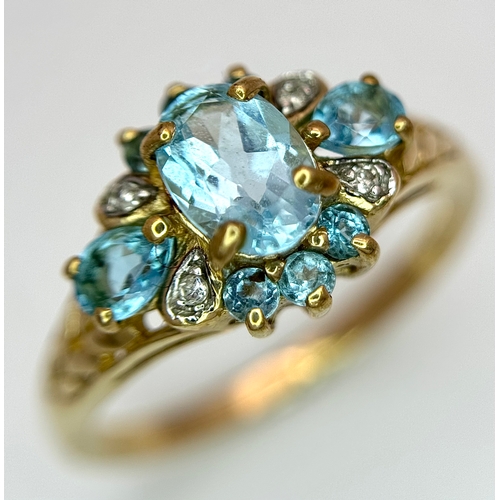 1266 - An Impressive 9K Gold Blue Topaz and Diamond Set Ring Size Q1/2. The Ring is set with a Centre Oval ... 
