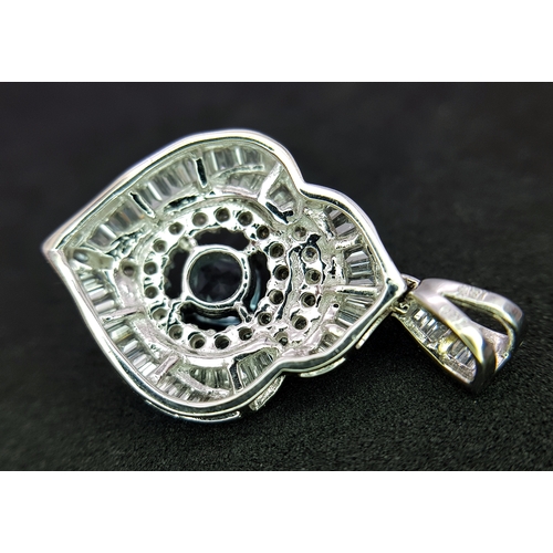 43 - AN 18K WHITE GOLD, DIAMOND AND AQUAMARINE SET, FANCY PENDANT. 0.90CTW. 9.6G. 6429