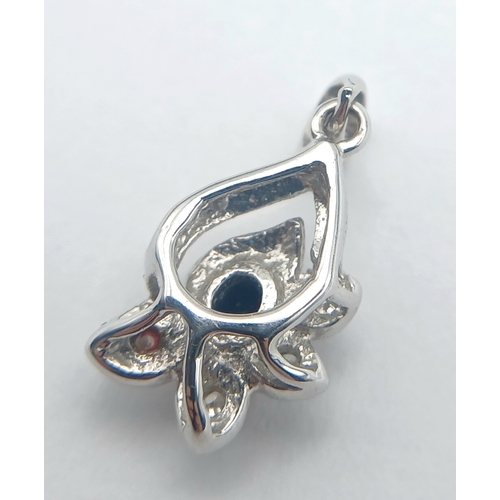 1262 - An 18K White Gold and Sapphire Pendant. 15mm. 1.1g. NL-7557.