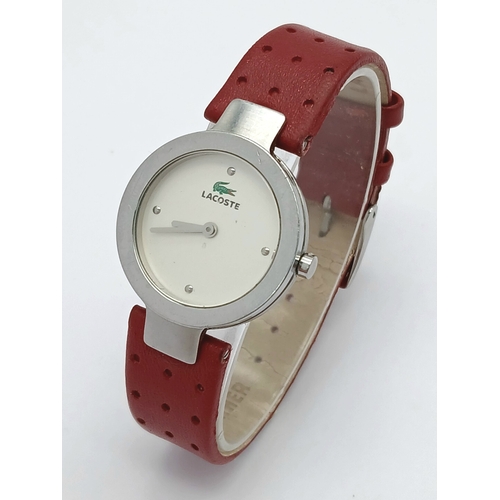 677 - A LACOSTE, RED LEATHER STRAP WATCH. ORIGINAL STRAP AND BUCKLE. IN FULL WORKING ORDER. NEW BATTERY FI... 