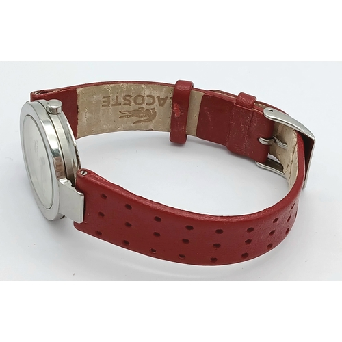 677 - A LACOSTE, RED LEATHER STRAP WATCH. ORIGINAL STRAP AND BUCKLE. IN FULL WORKING ORDER. NEW BATTERY FI... 