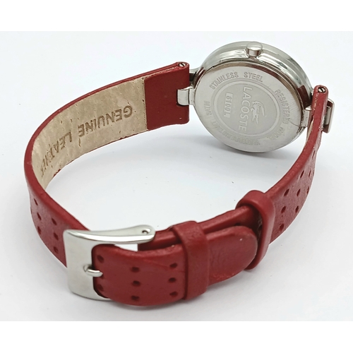 677 - A LACOSTE, RED LEATHER STRAP WATCH. ORIGINAL STRAP AND BUCKLE. IN FULL WORKING ORDER. NEW BATTERY FI... 