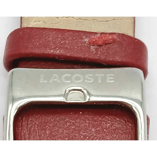 677 - A LACOSTE, RED LEATHER STRAP WATCH. ORIGINAL STRAP AND BUCKLE. IN FULL WORKING ORDER. NEW BATTERY FI... 