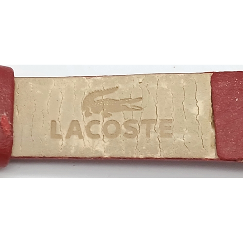 677 - A LACOSTE, RED LEATHER STRAP WATCH. ORIGINAL STRAP AND BUCKLE. IN FULL WORKING ORDER. NEW BATTERY FI... 
