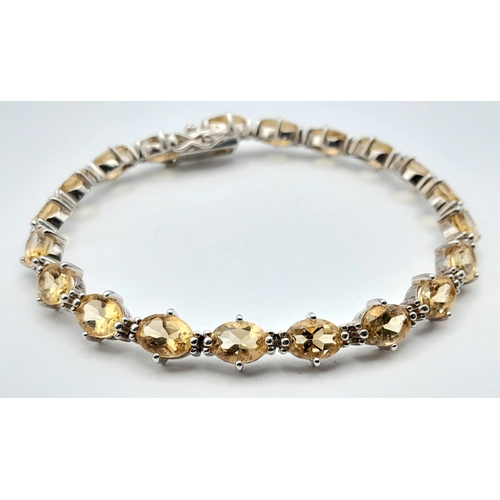 720 - An Elegant Sterling Silver and Citrine Set Tennis Bracelet-18.5cm Length. Set with Twenty 6 x 5mm Ov... 