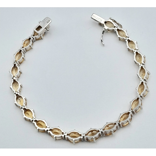 720 - An Elegant Sterling Silver and Citrine Set Tennis Bracelet-18.5cm Length. Set with Twenty 6 x 5mm Ov... 